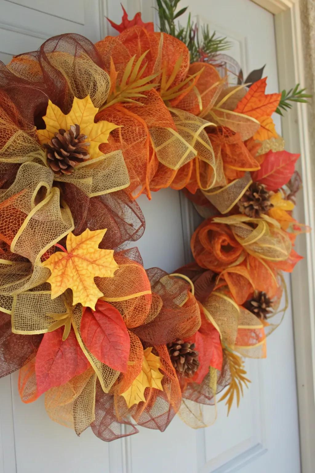 A quintessential autumn-themed wreath showcasing deco mesh and seasonal leaves.