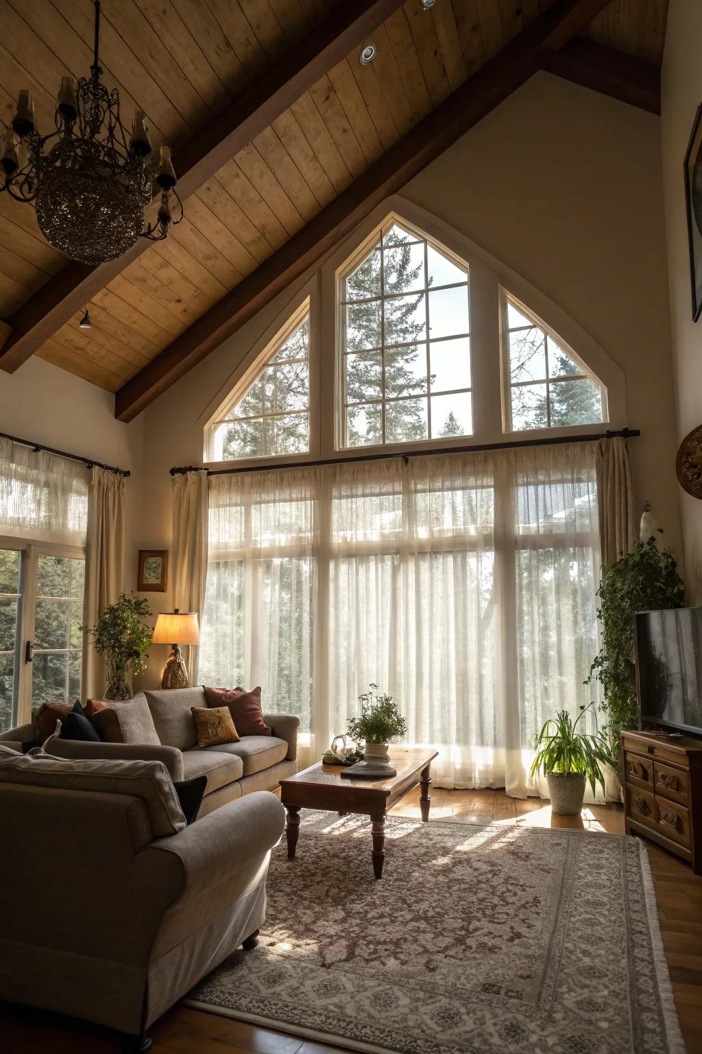 Sheer curtains enhance natural light in a living room with a high ceiling.