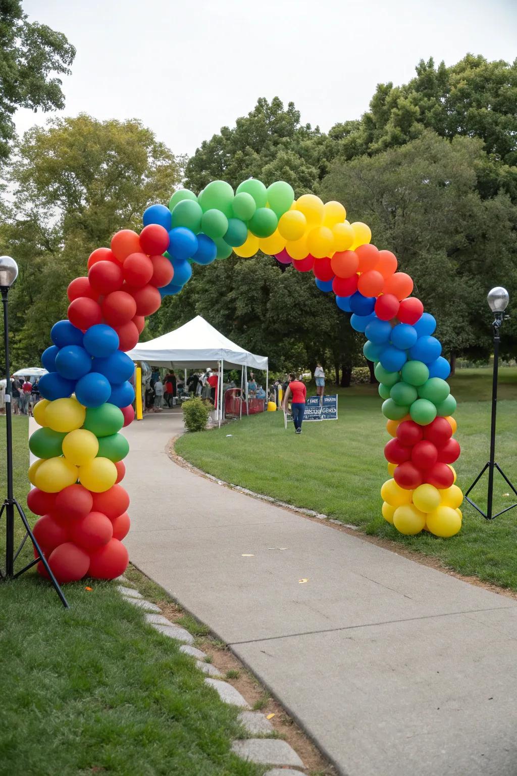 A vibrant air-filled gateway sets the stage for a celebratory park gathering.