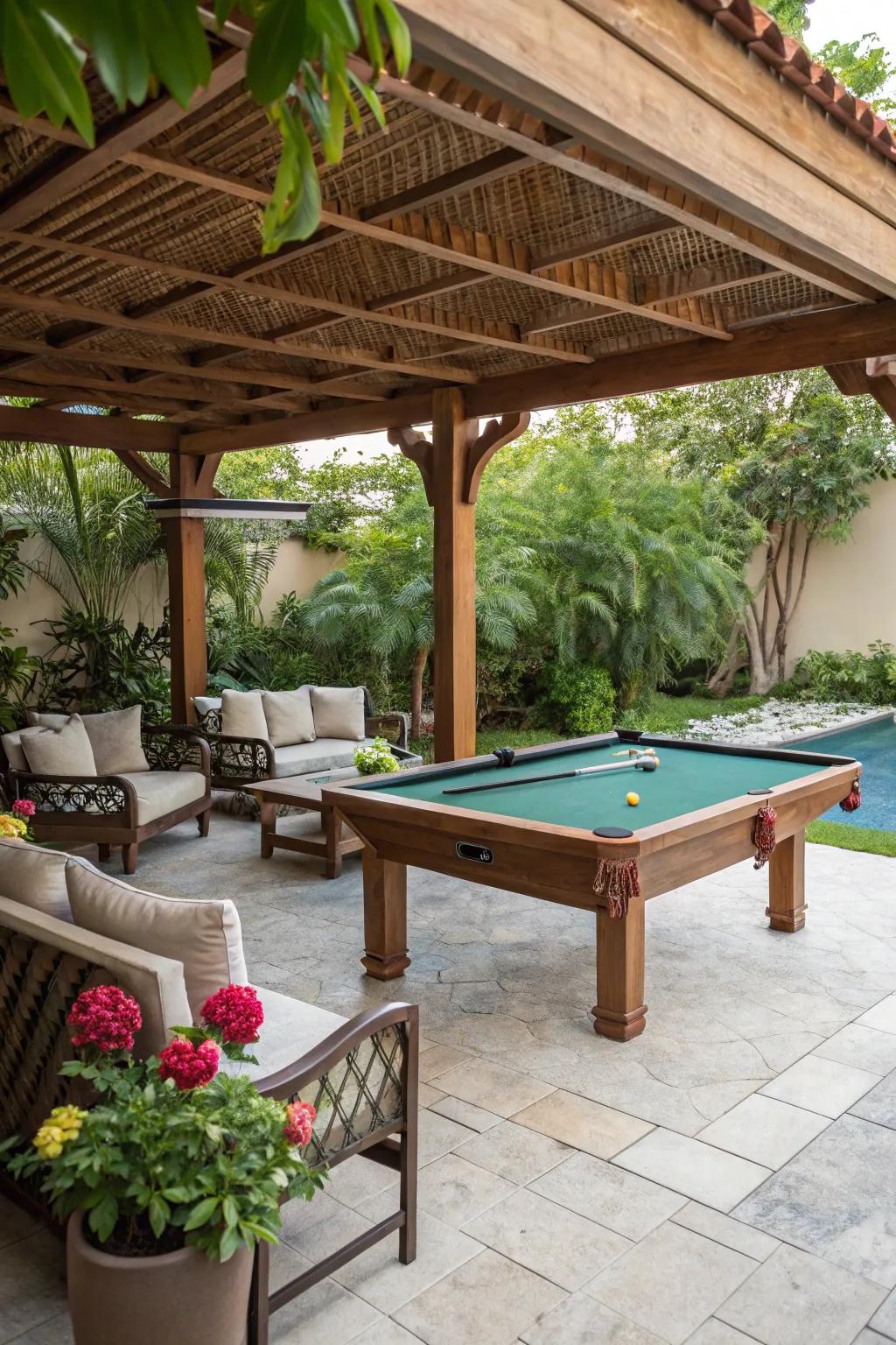A snug snooker table setup under a wooden canopy with seating and garden foliage.