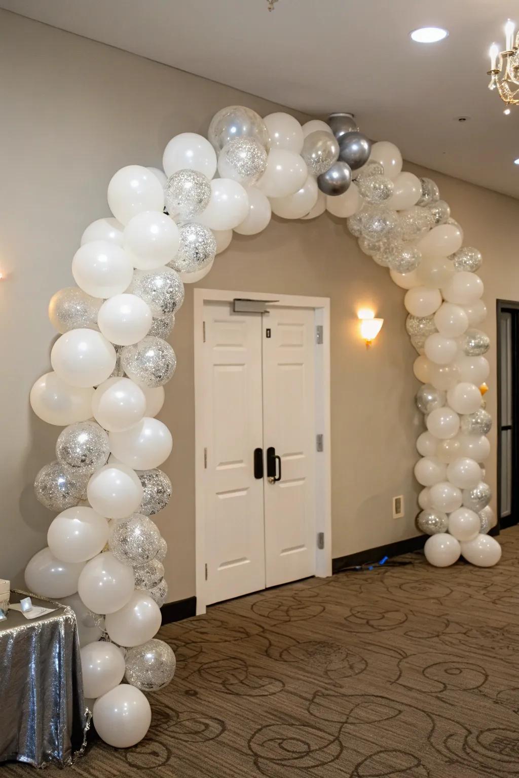 Celebrate stylishly with a show-stopping white and silver balloon garland.