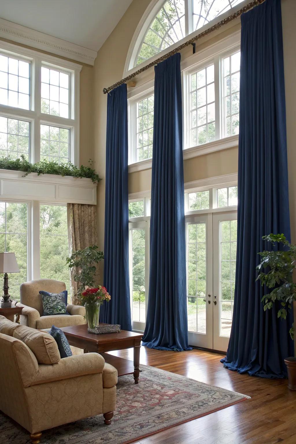 Elegant full-length drapes add height and drama to this glam living space.