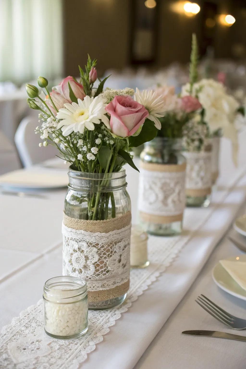 Preserving-style jars wrapped in lace for an elegant centerpiece.