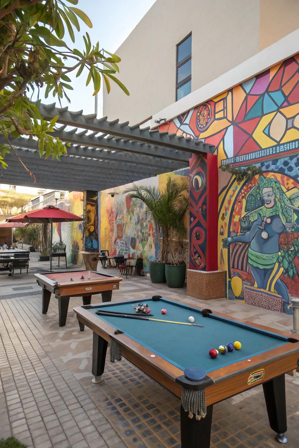 An artistic outdoor snooker table area with murals and sculptures.