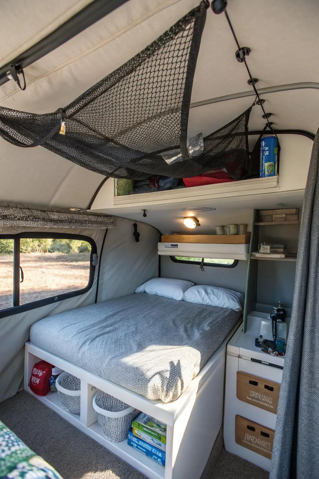 Ceiling storage nets in a camper help keep lightweight items organized.