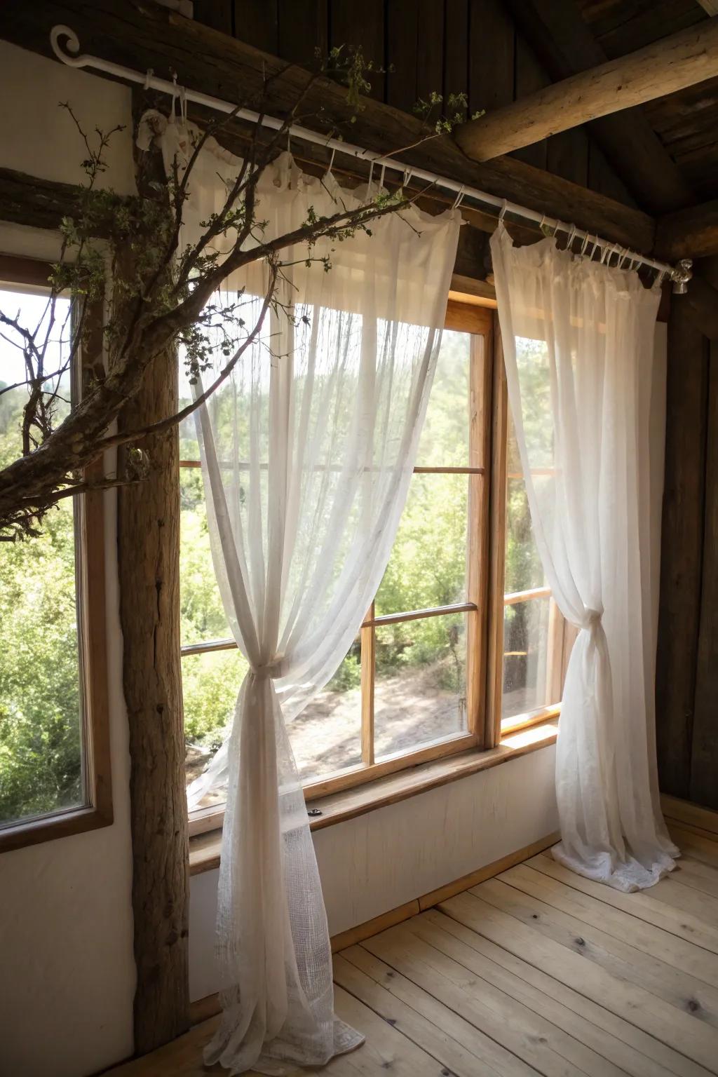 A countryside-themed window exhibiting a branch-constructed curtain rod.