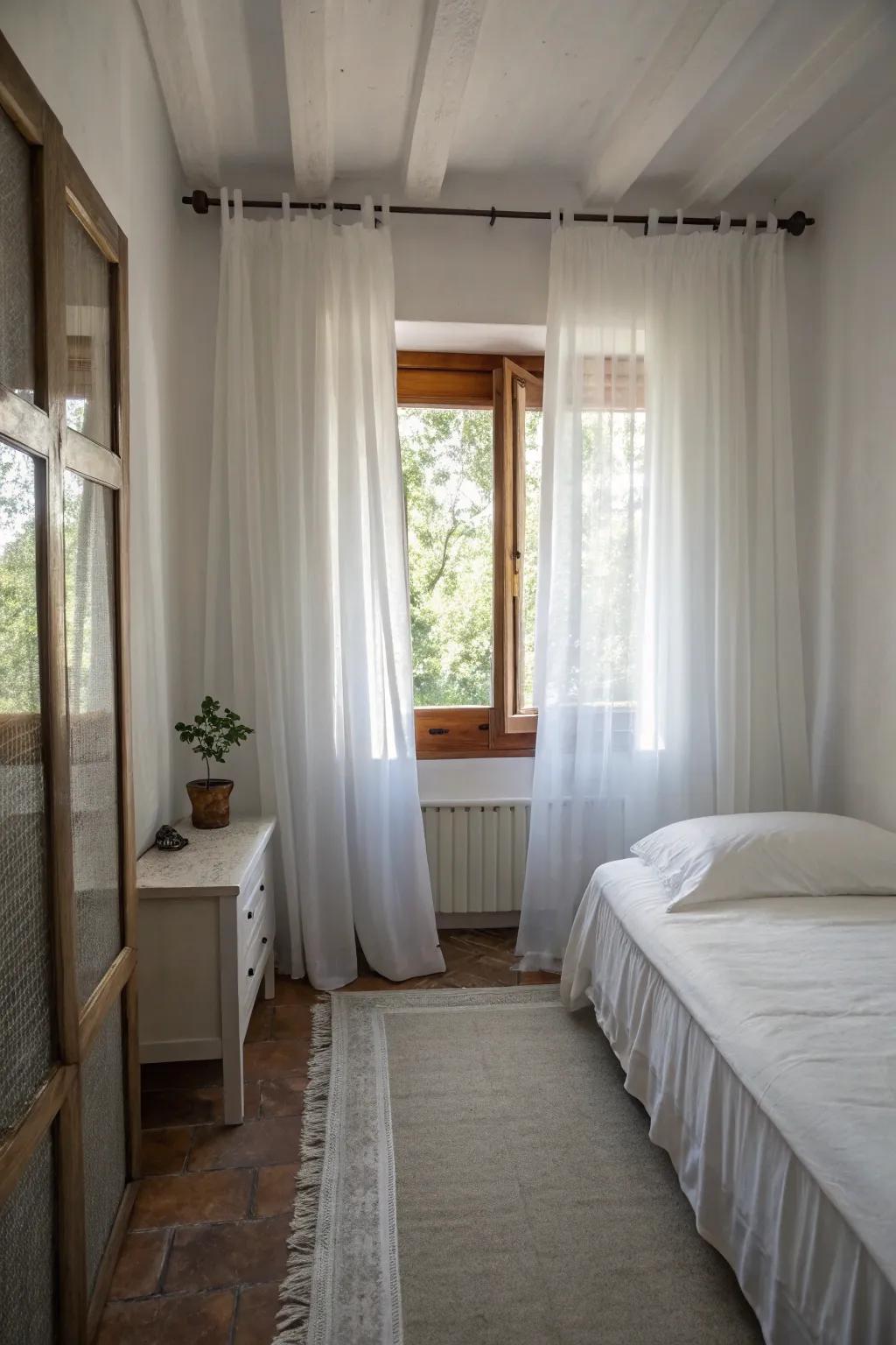 Ivory drapes help make this small bedroom feel larger.