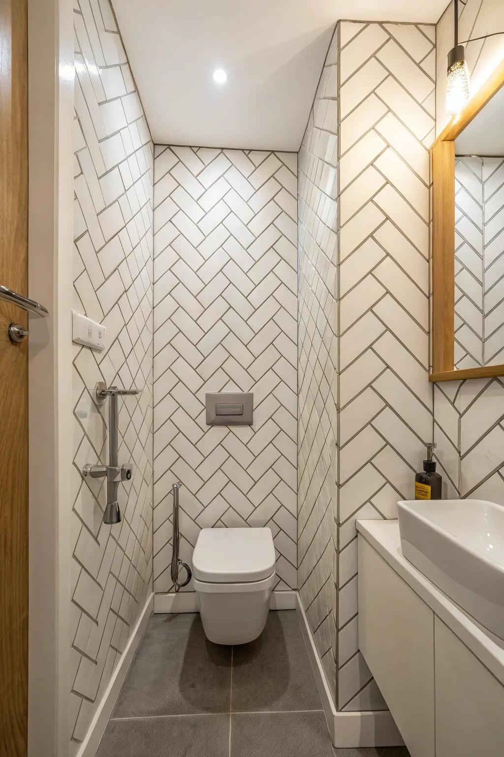 Vertical herringbone tiles lift the eye, adding a sense of height and openness to this compact bathroom.