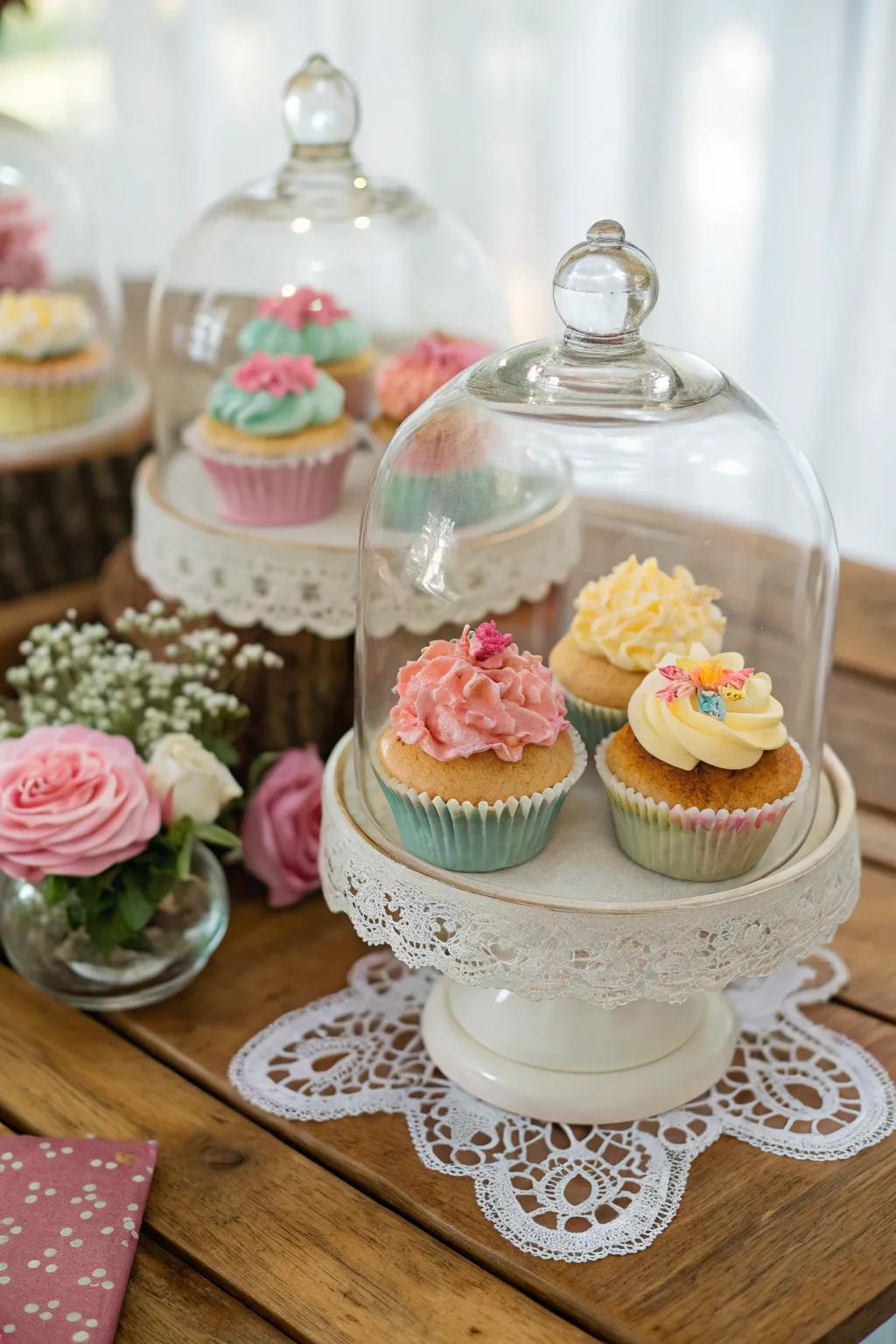 Glass cloches give the cupcake display a refined and elegant feel.