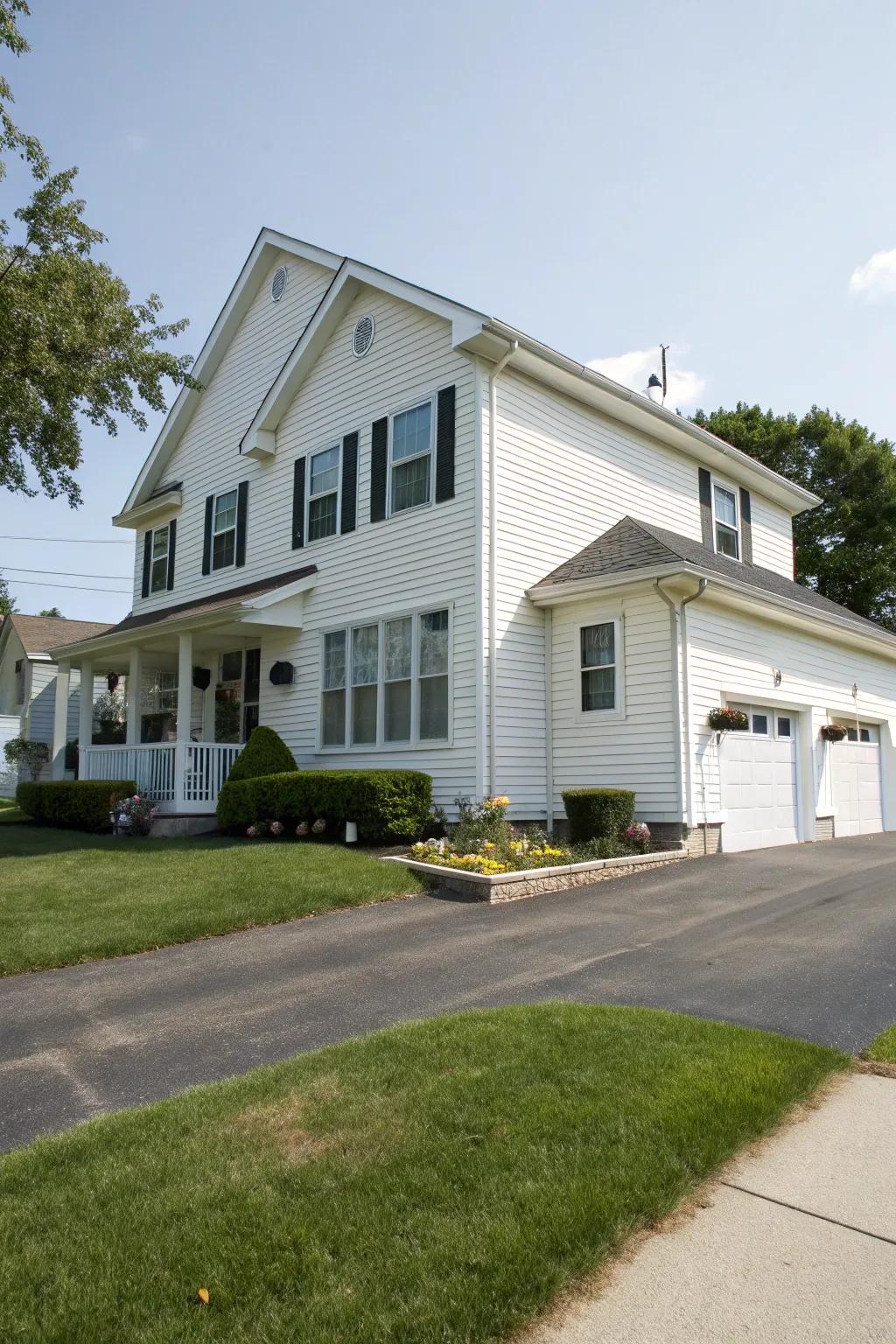 A grand multi-story house featuring white vinyl siding.