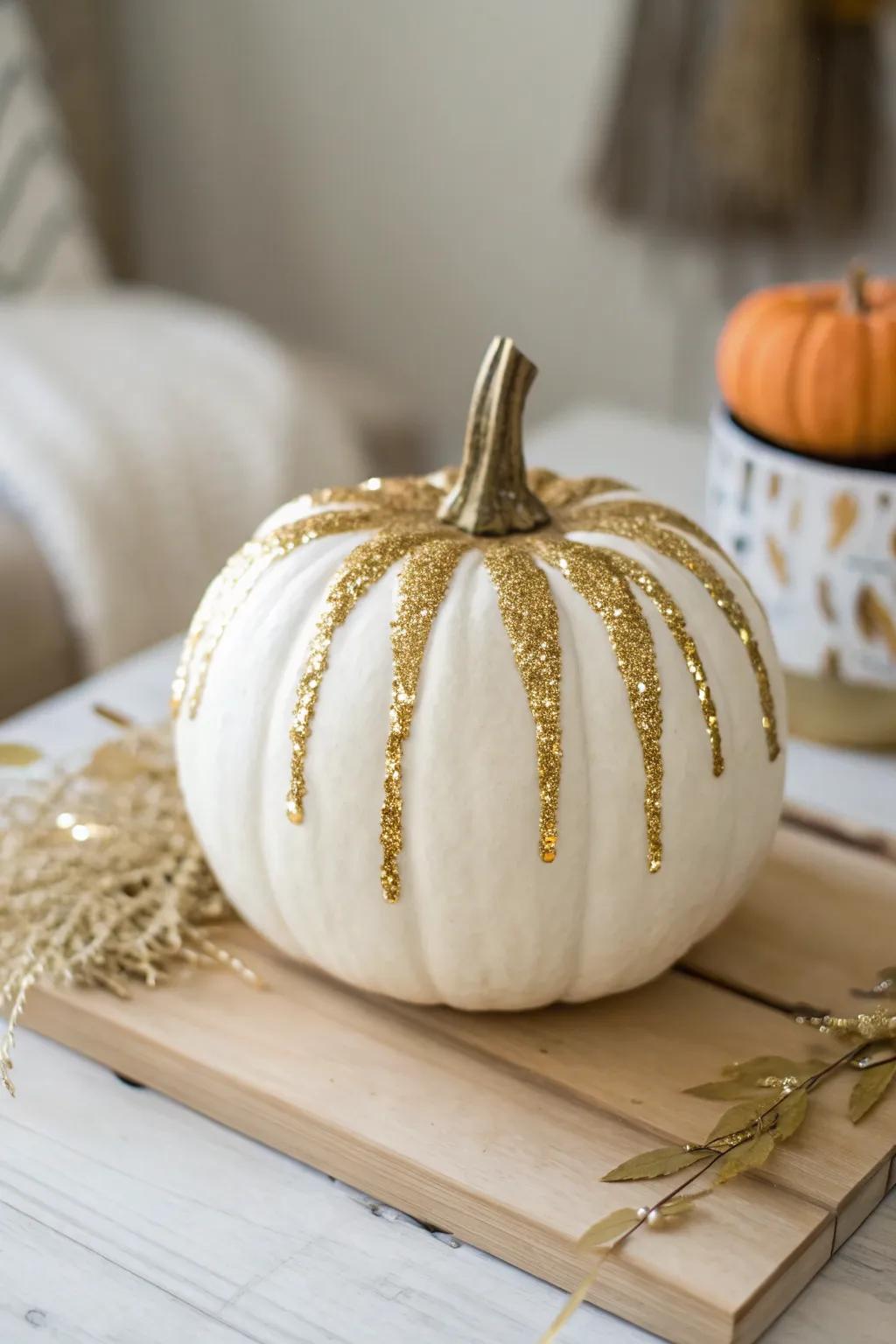 Embrace the art of simplicity with a touch of sparkle: A glitter-dripped pumpkin for a chic autumn centerpiece.
