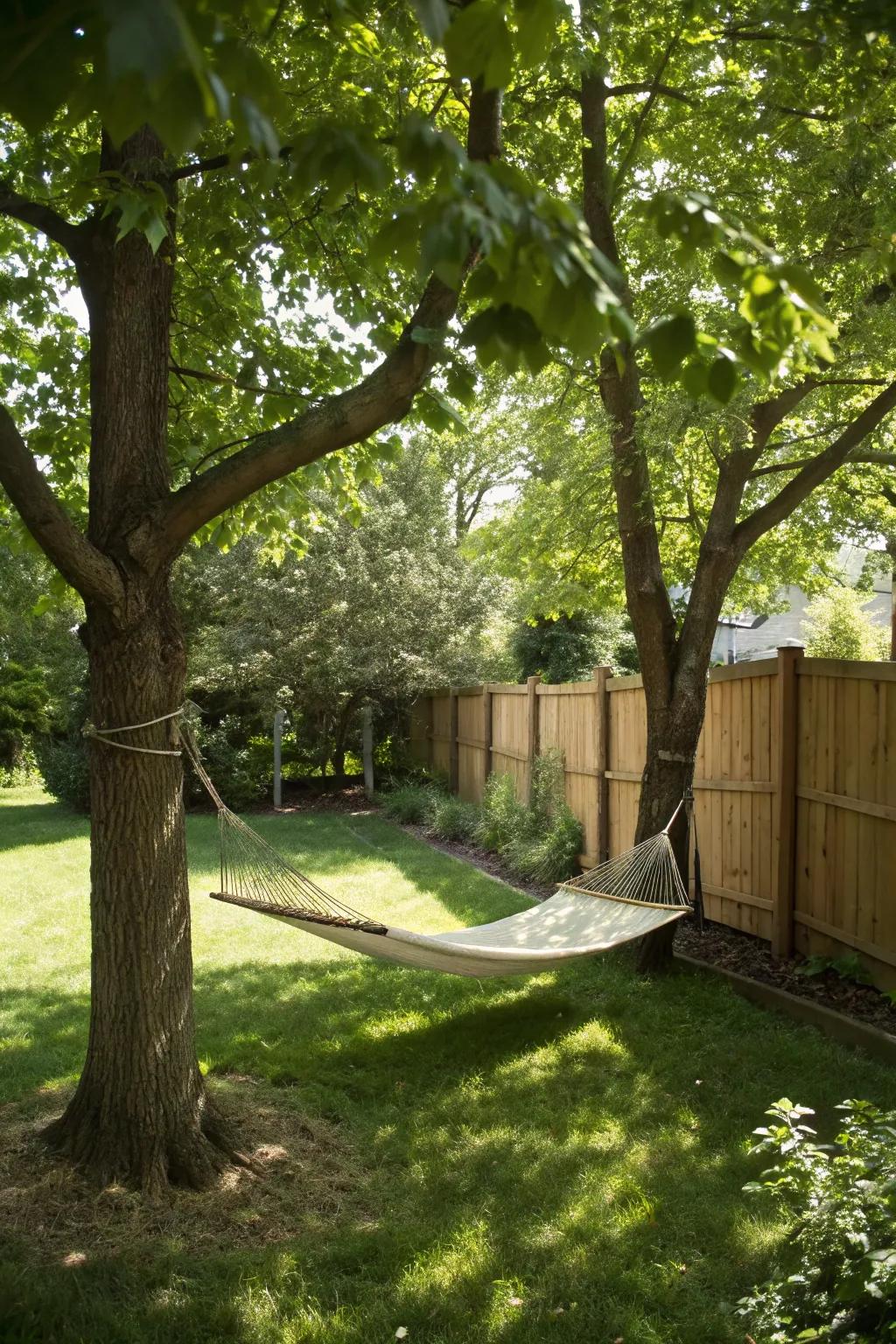 A hammock hung between trees, creating a relaxing escape in the garden.