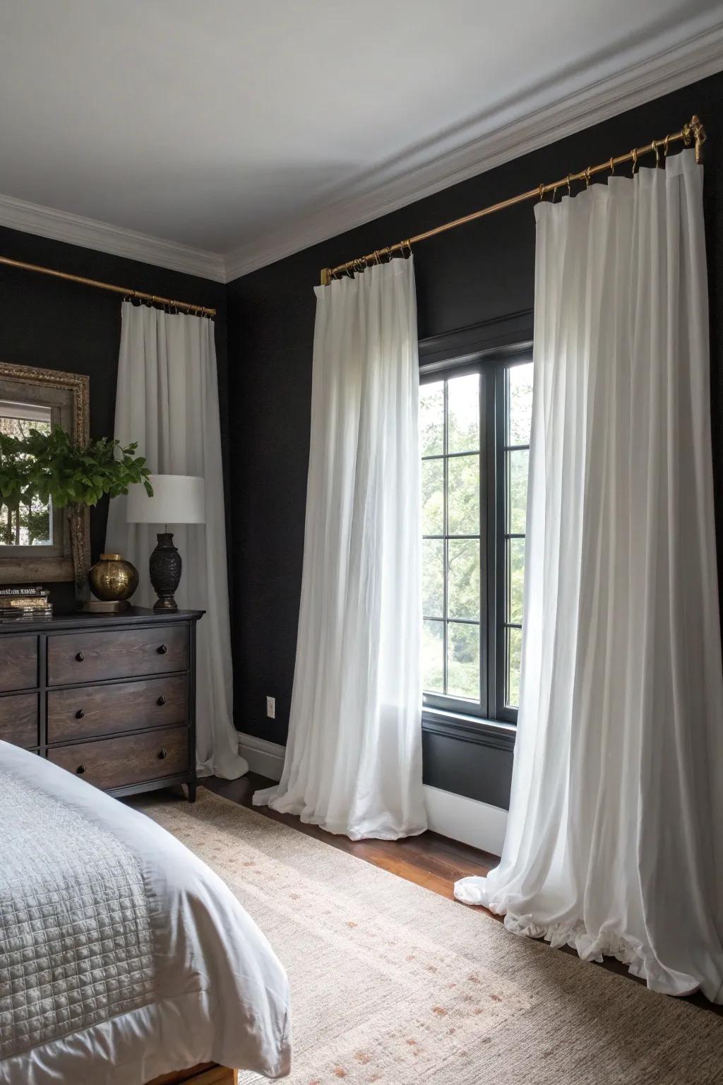 Ivory drapes give a striking contrast to dark elements in the room.