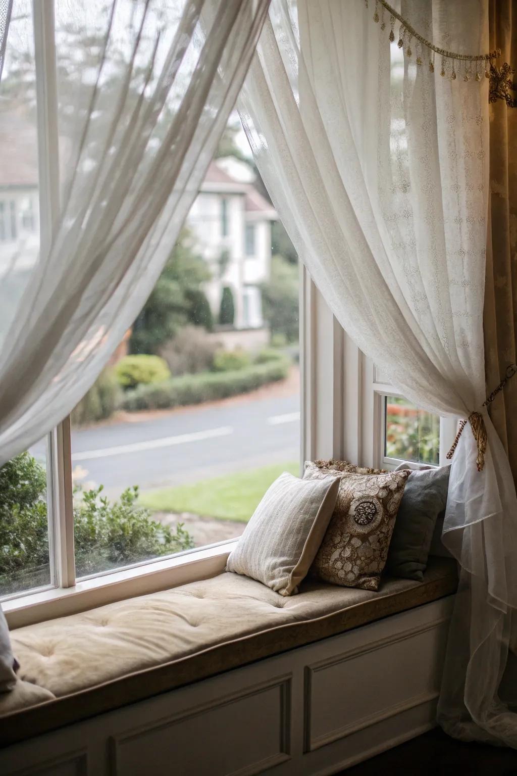 A window seat with drapes that provide added privacy and an elegant touch.