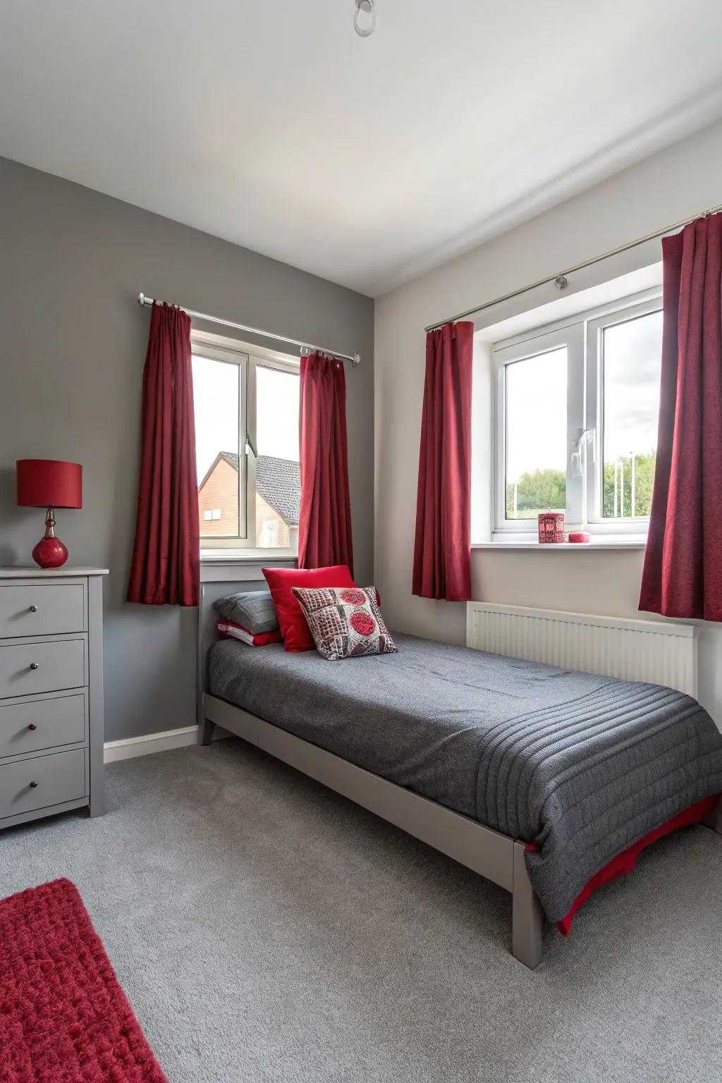 A minimalistic approach in a small bedroom with select crimson and ash-grey d&eacute;cor pieces.