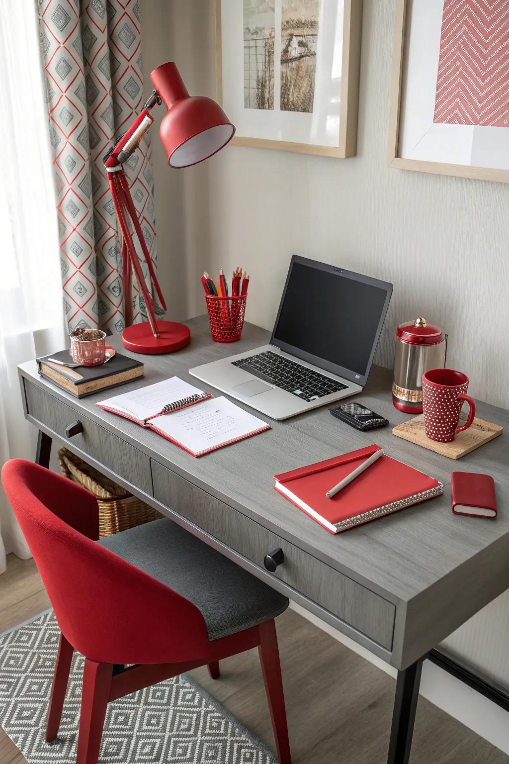 The office space has a grey desk and vibrant rouge accessories.