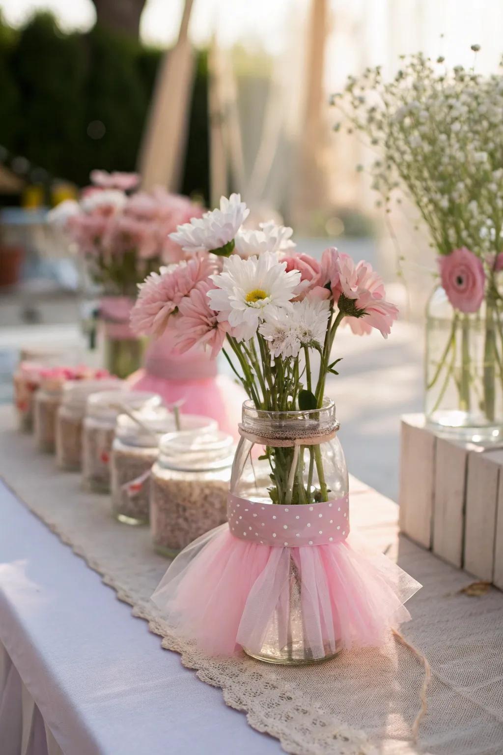 Whimsical centerpieces feature miniature tutus and delicate floral elements.