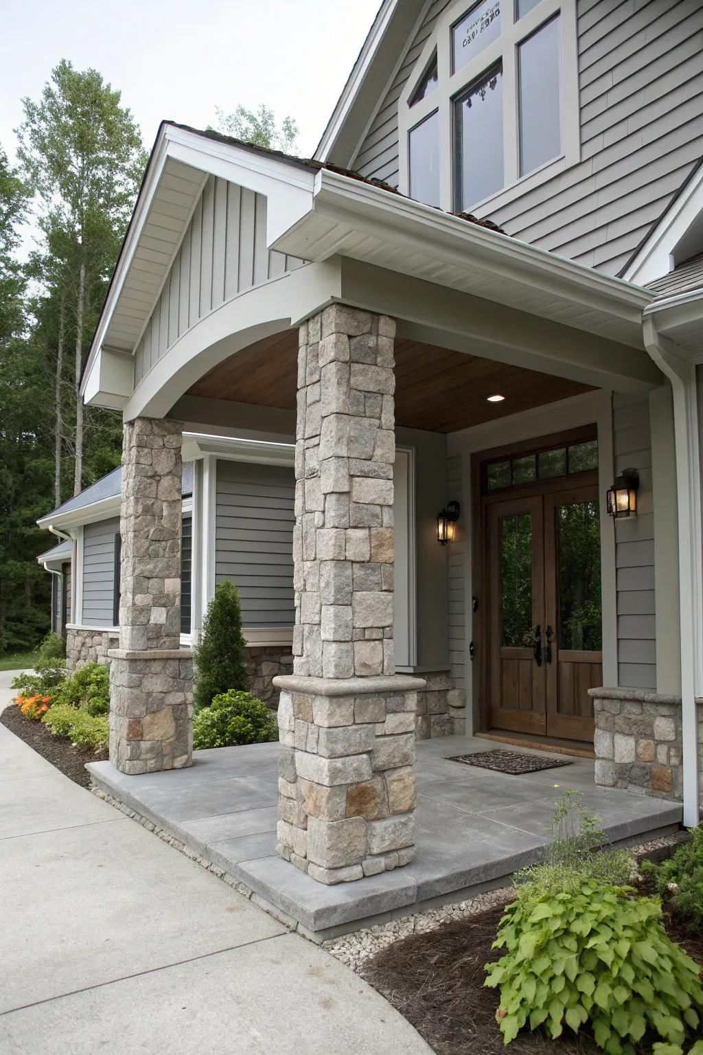 Grand entrance featuring grey tones and stone columns.