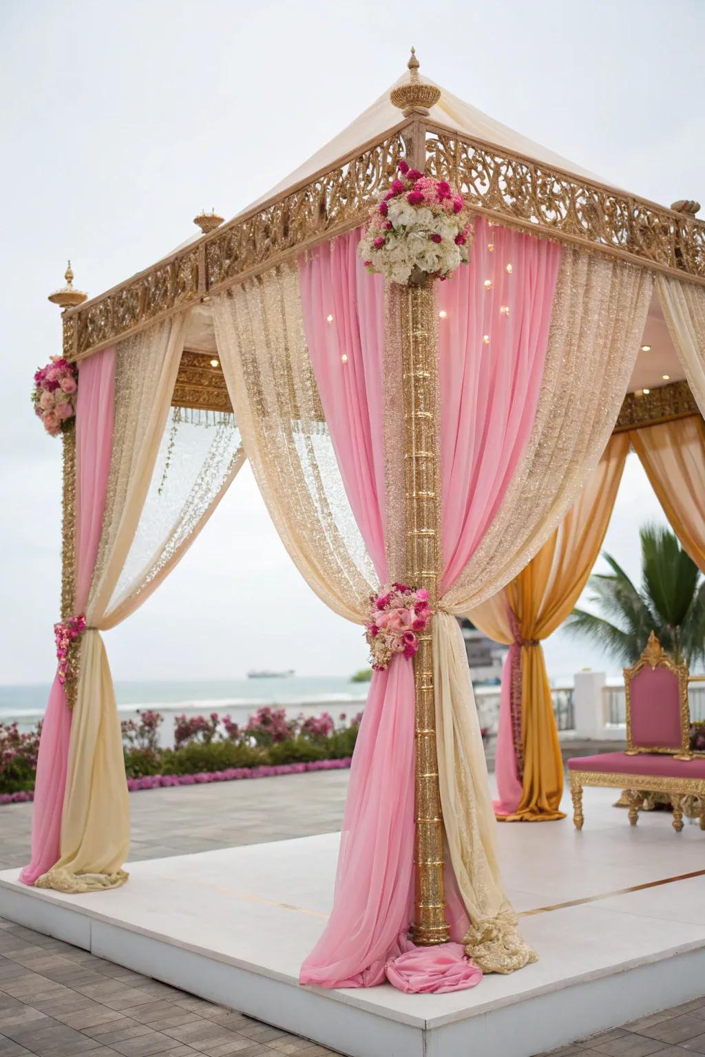 Lavish flowing textiles in gold and blush gracefully enveloping a mandap.