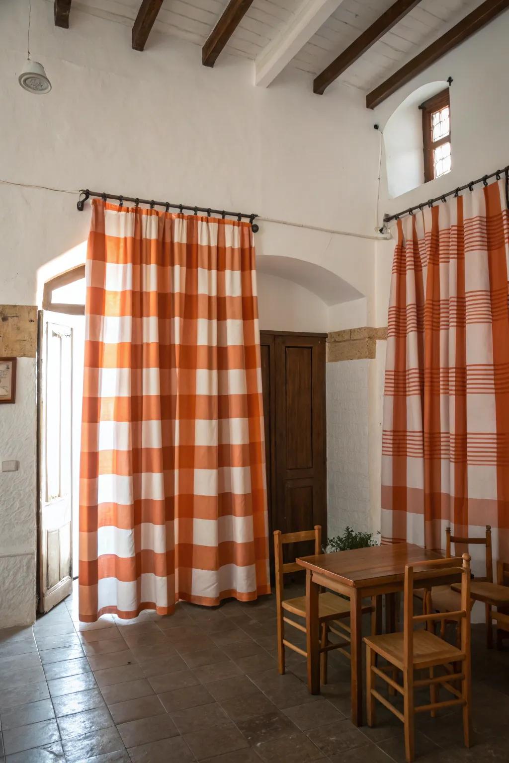 Playful orange and white patterned window coverings brighten up a neutral room.