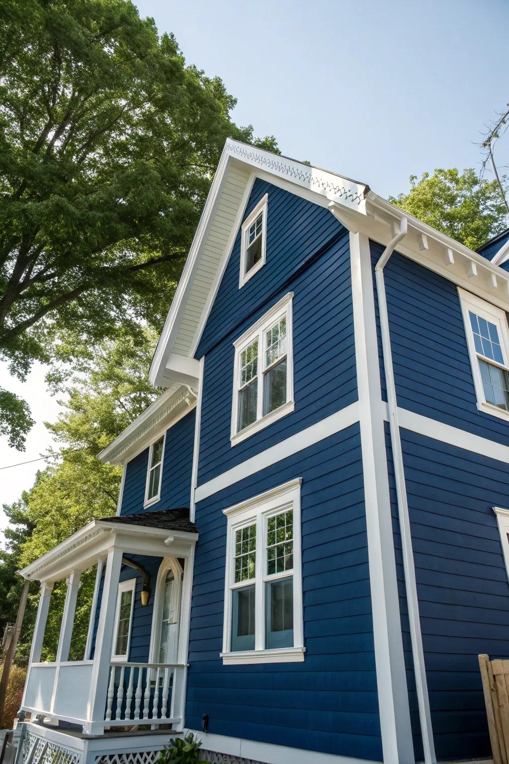 A house with striking deep blue siding and contrasting pure white trim.