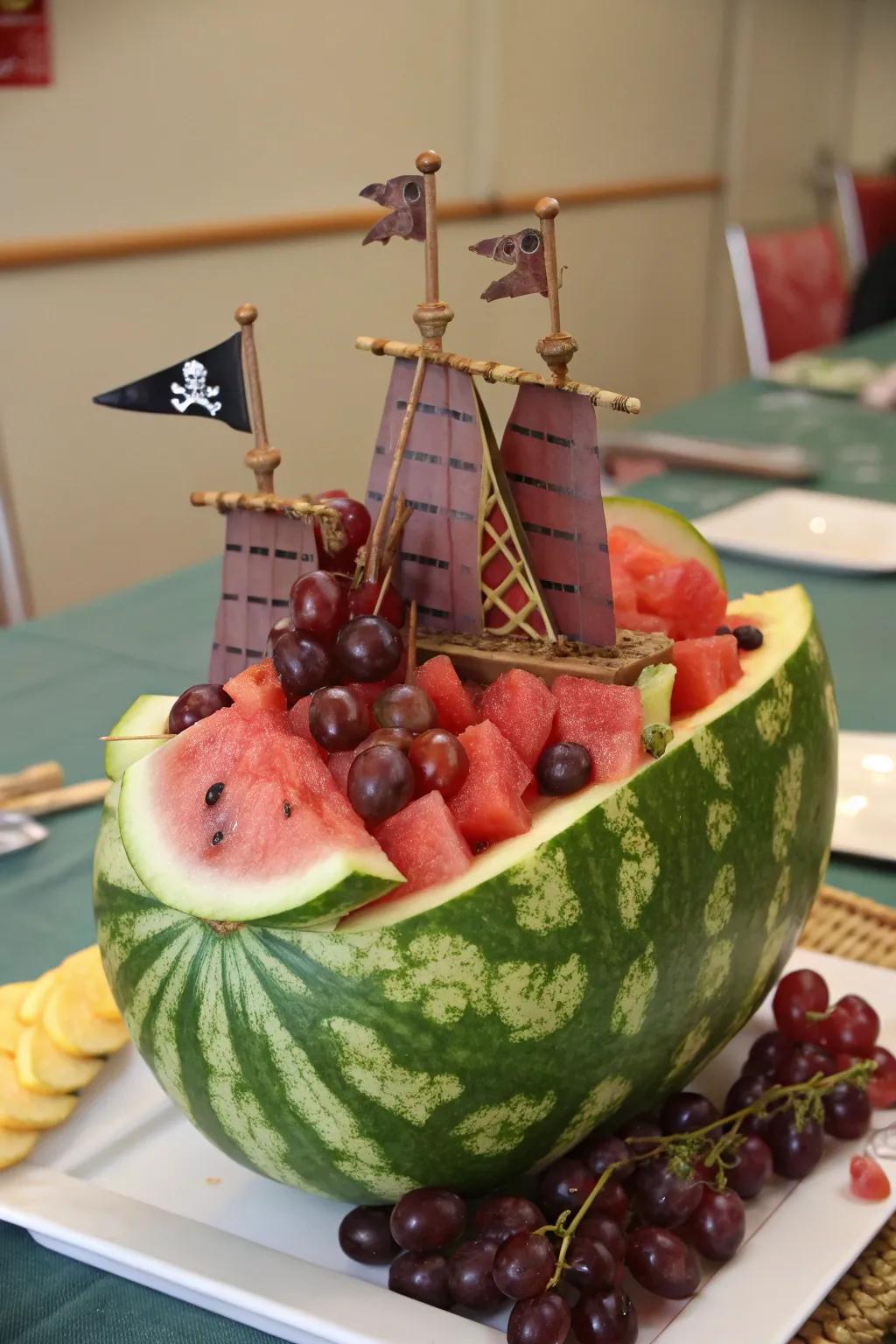 A pirate-themed watermelon ship complete with a flag and grape cannons.
