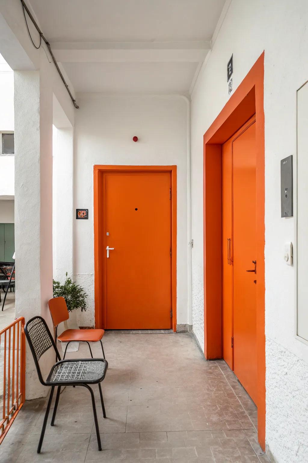 A bold orange door and white walls create a welcoming entryway.