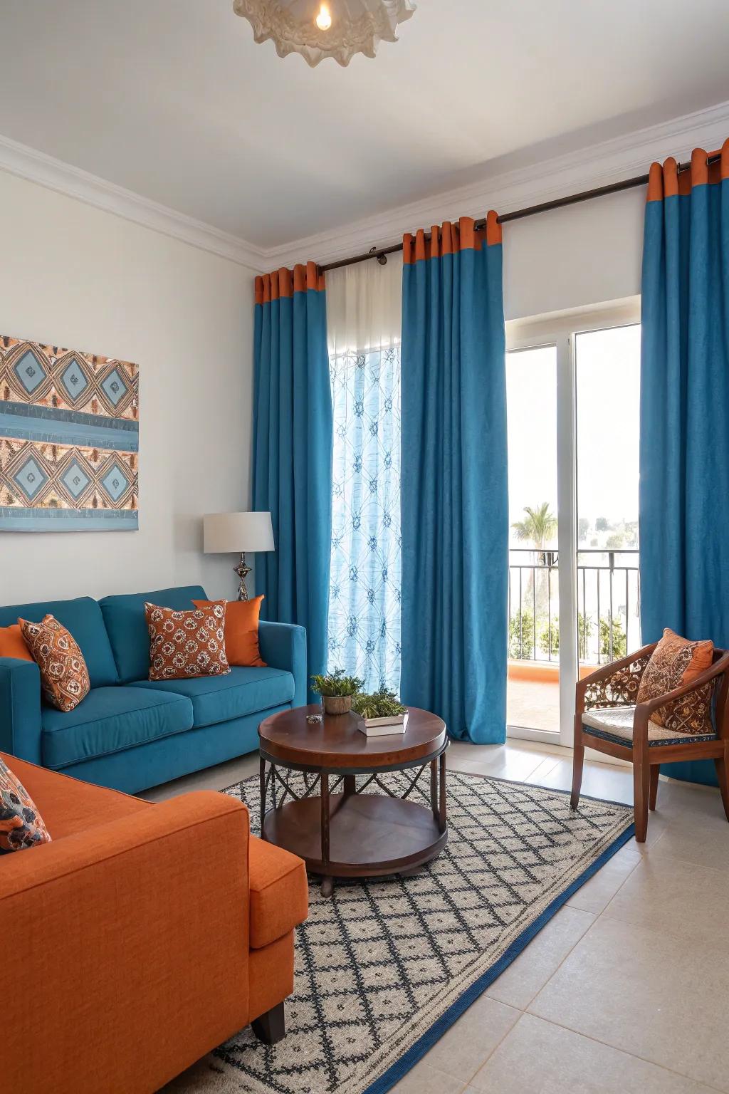 Vibrant orange accents provide a lively contrast to the calming blue curtains, adding energy to the room.