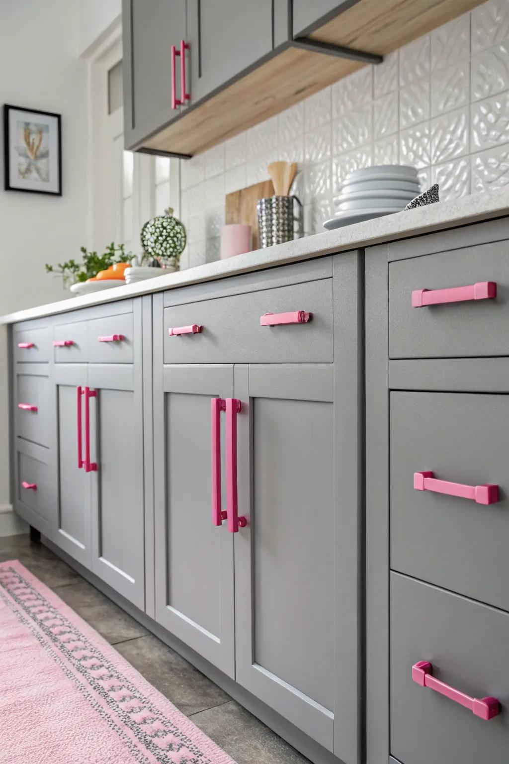 Grey cabinets adorned with pink handles, offering a playful sophistication.