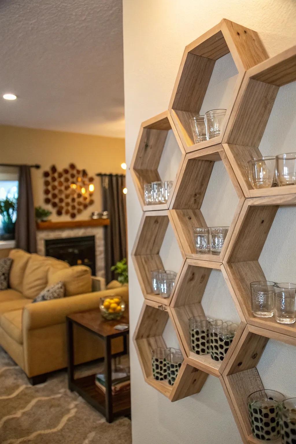 A wall within a living area features hexagonal shelves, housing shot glasses arranged in a honeycomb arrangement.