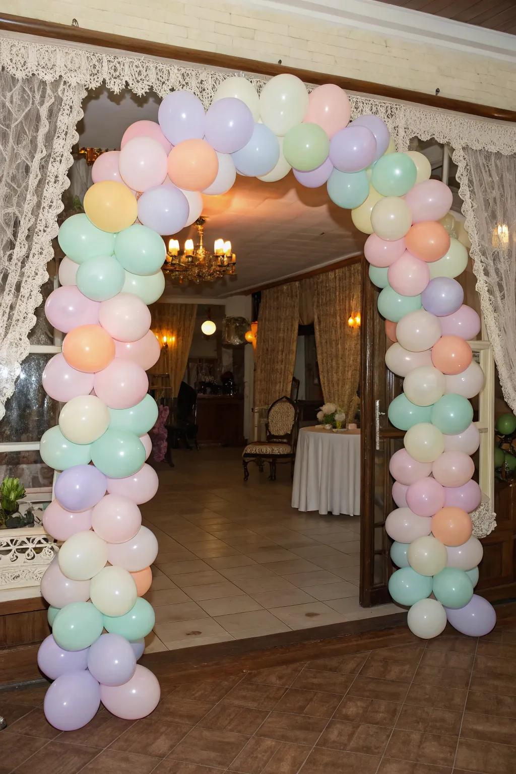 A delightful pastel balloon arch warmly welcomes guests.