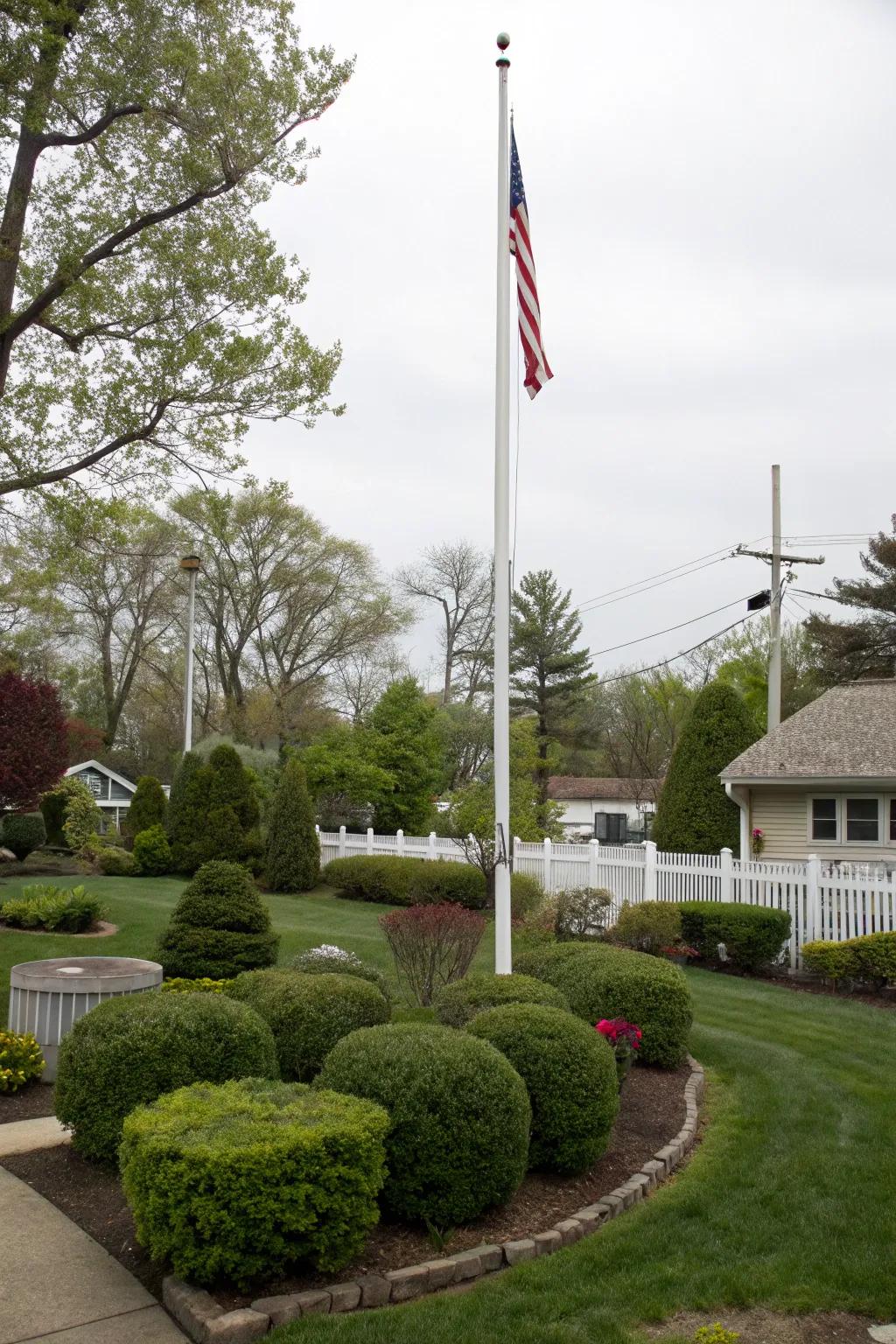 Shrubbery and bushes offer a lush backdrop suitable for any flagpole.