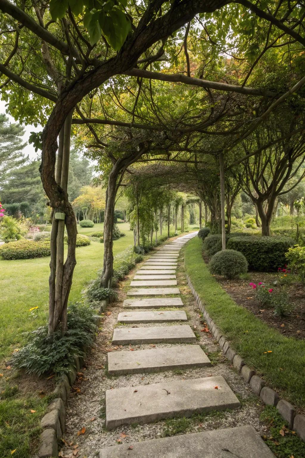 A pretty walkway has trees and stepping stones along it.