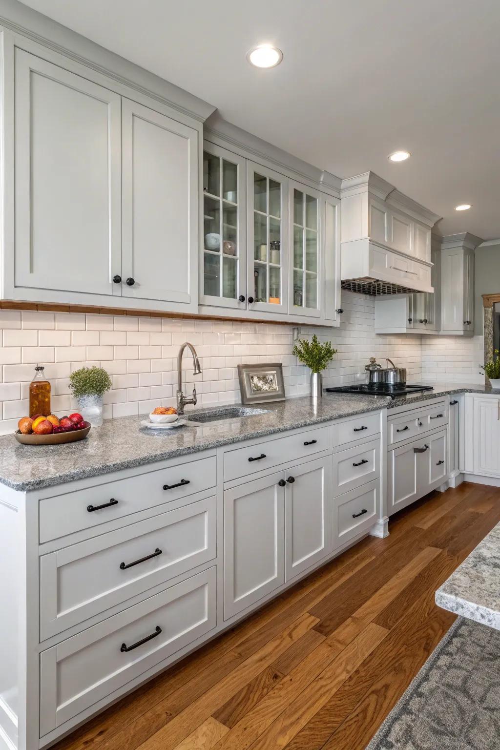 Grey countertops perfectly complement the white cabinetry.