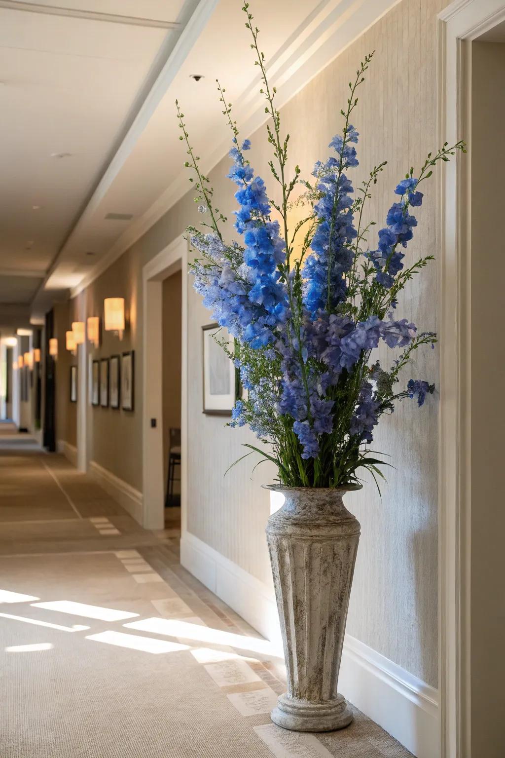 Soaring stems of larkspurs contributing sophistication to a corridor.