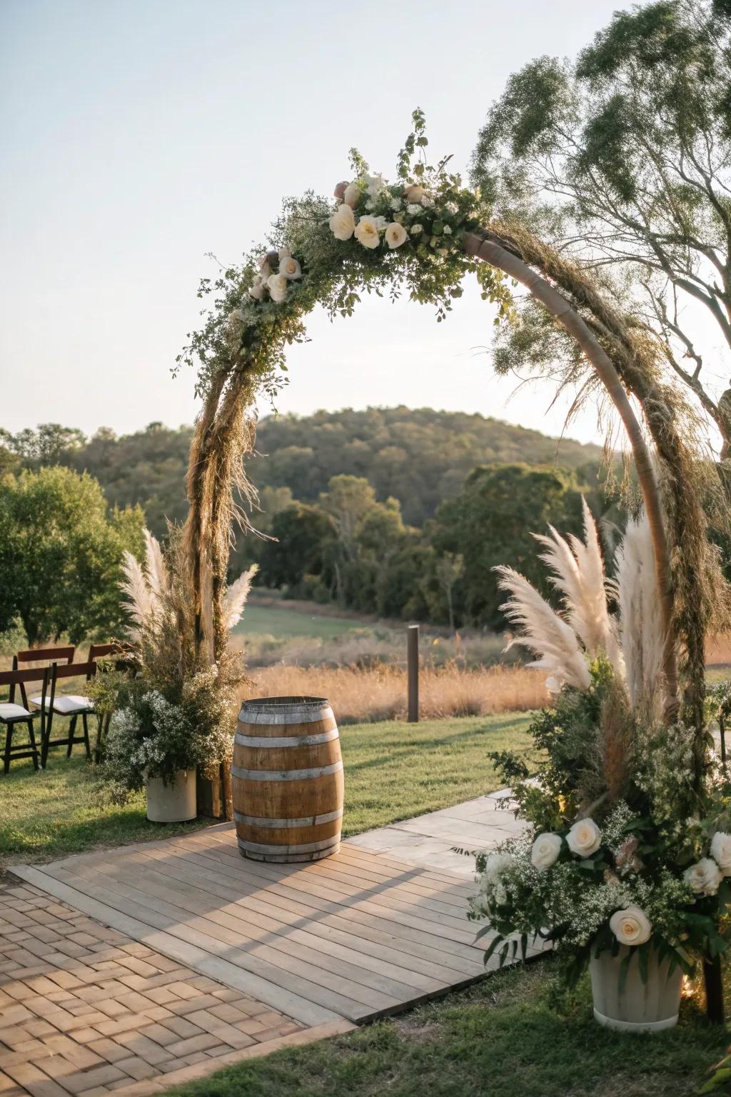 A rustic circular wedding arch adorned with pampas grass and branches.