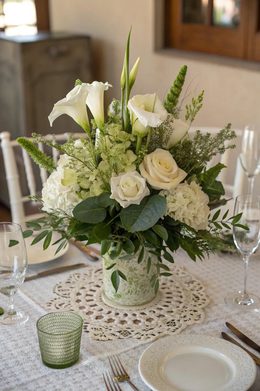 An ageless centerpiece featuring ivory flowers and abundant greenery.