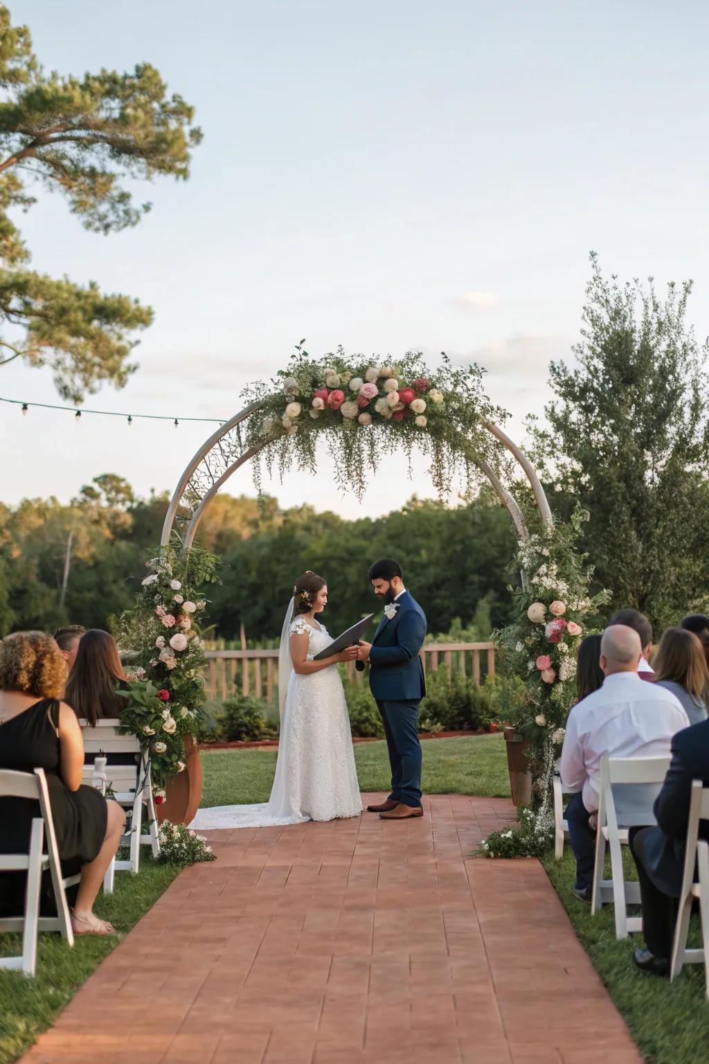 An outdoor wedding ceremony featuring a wonderfully adorned arch.