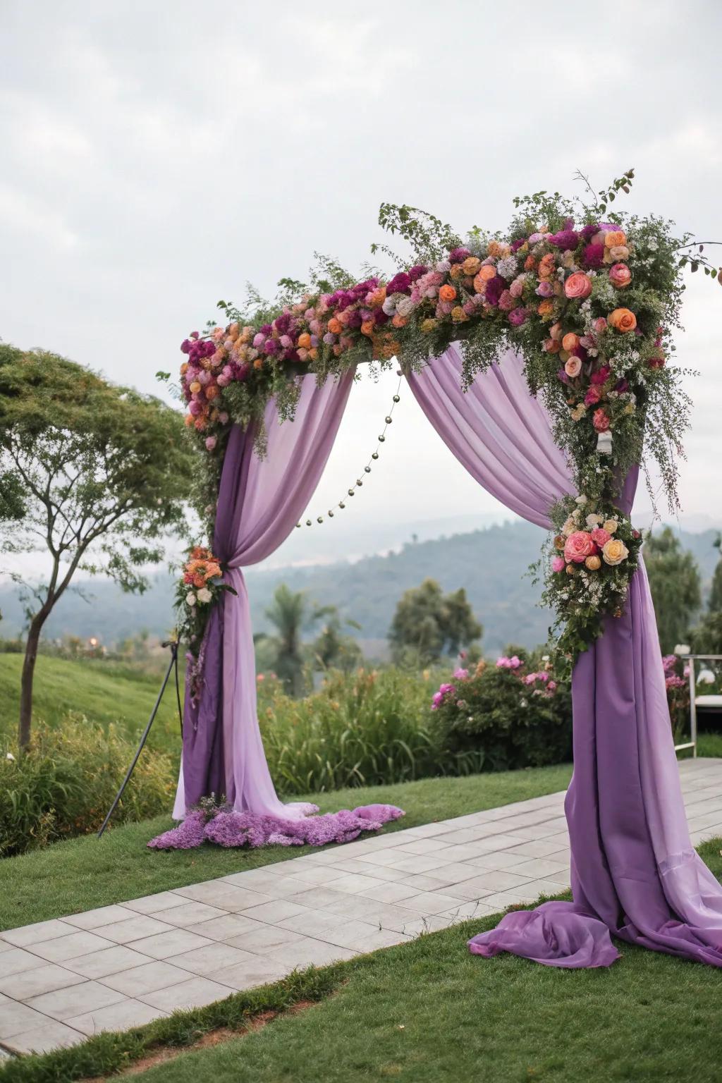 A purple draped ceremony arch makes a romantic focal point.