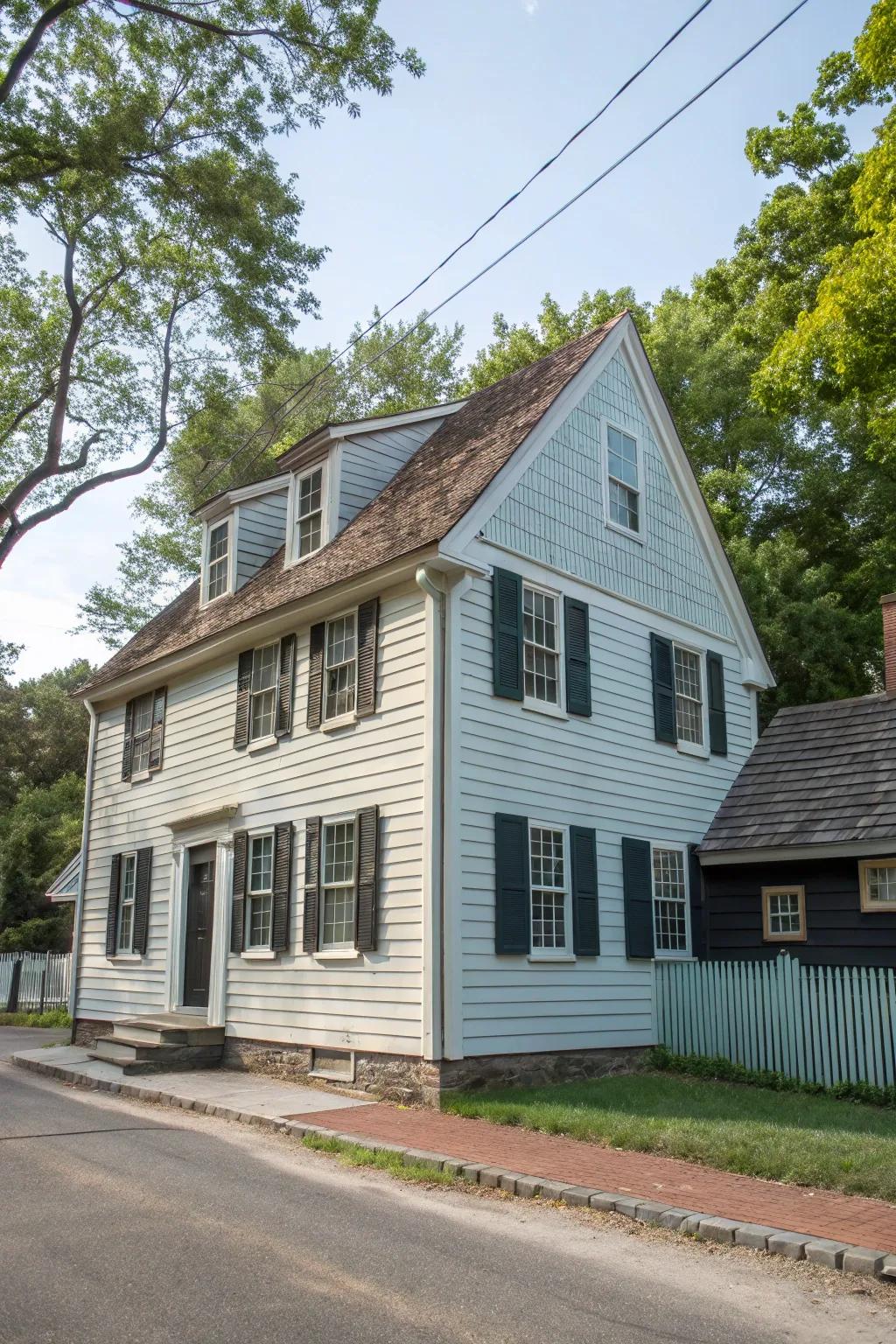 A colonial house showcasing a stylish dual-tone frontage with clapboards and shingles.