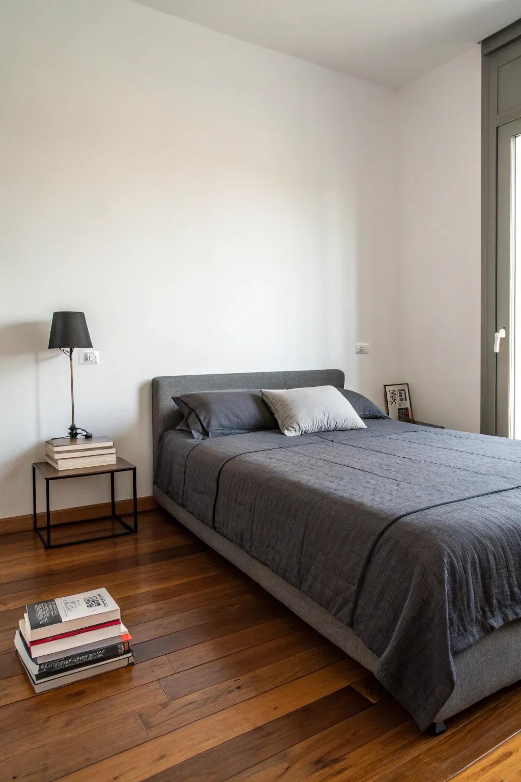 Minimalism and dark grey bedding create a tranquil retreat.