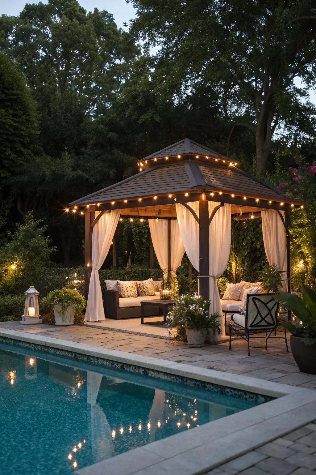 Overhead lighting in a gazebo crafts a cozy gathering spot adjacent to the pool.