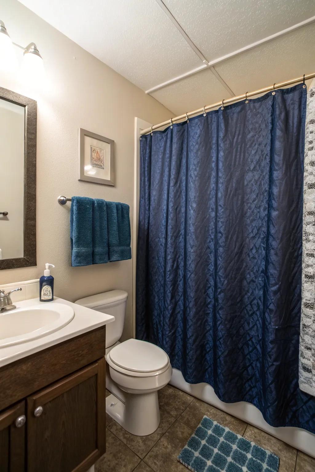 Dark blue water shields add a bold statement to this compact bathroom.