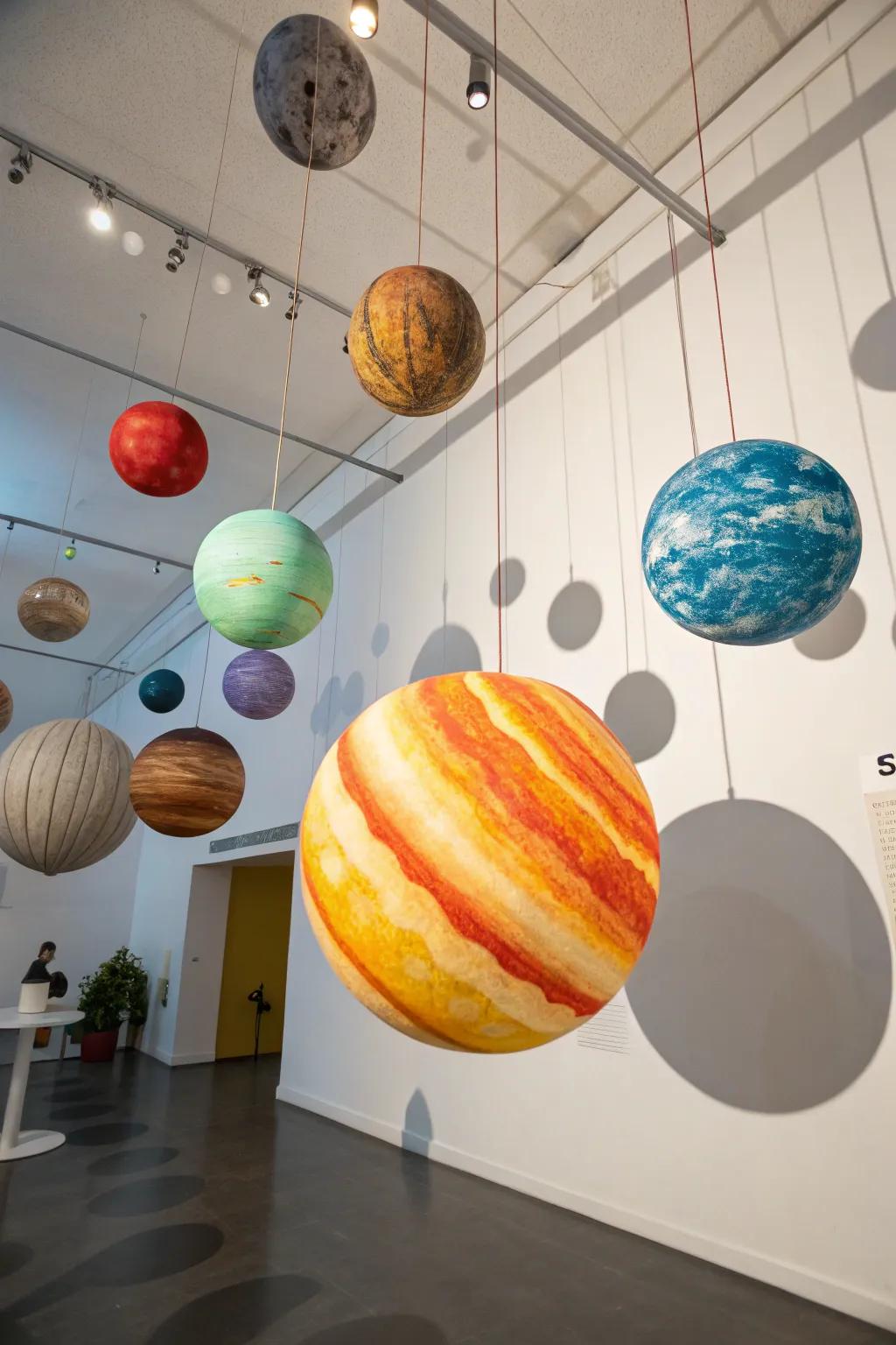 Welcome the galaxy inside with hanging world sculptures.