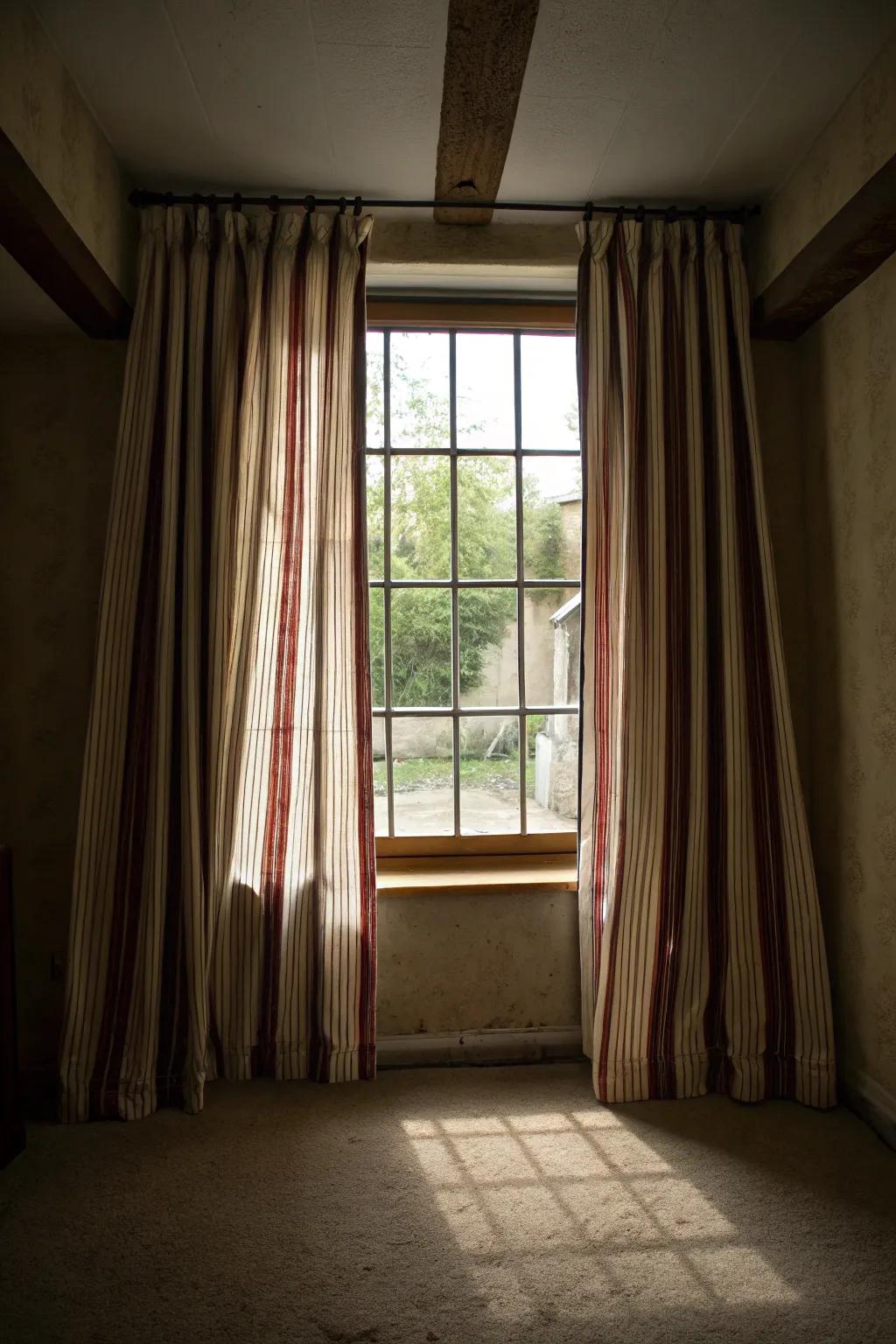 Striped curtains can visually enhance the space.