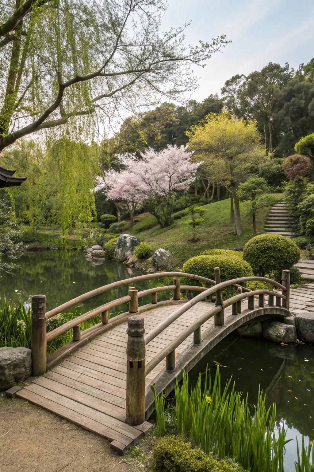 A naturalistic timber bridge over a pond in a Japanese garden.