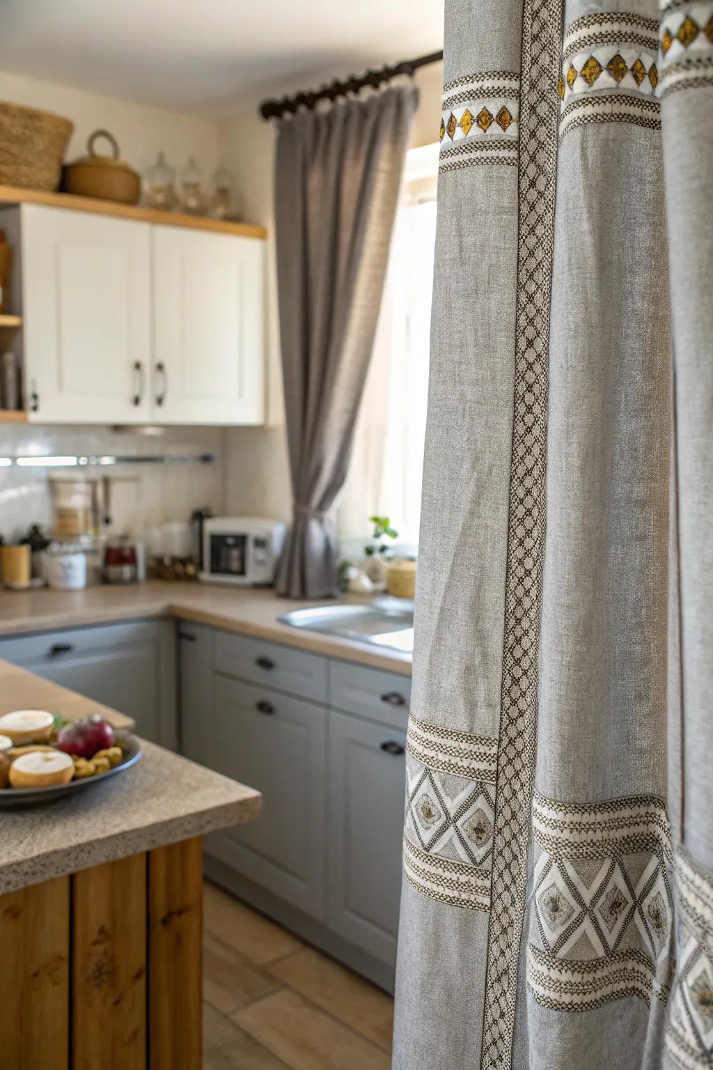 Textured gray drapes add a tangible opulence to the kitchen.