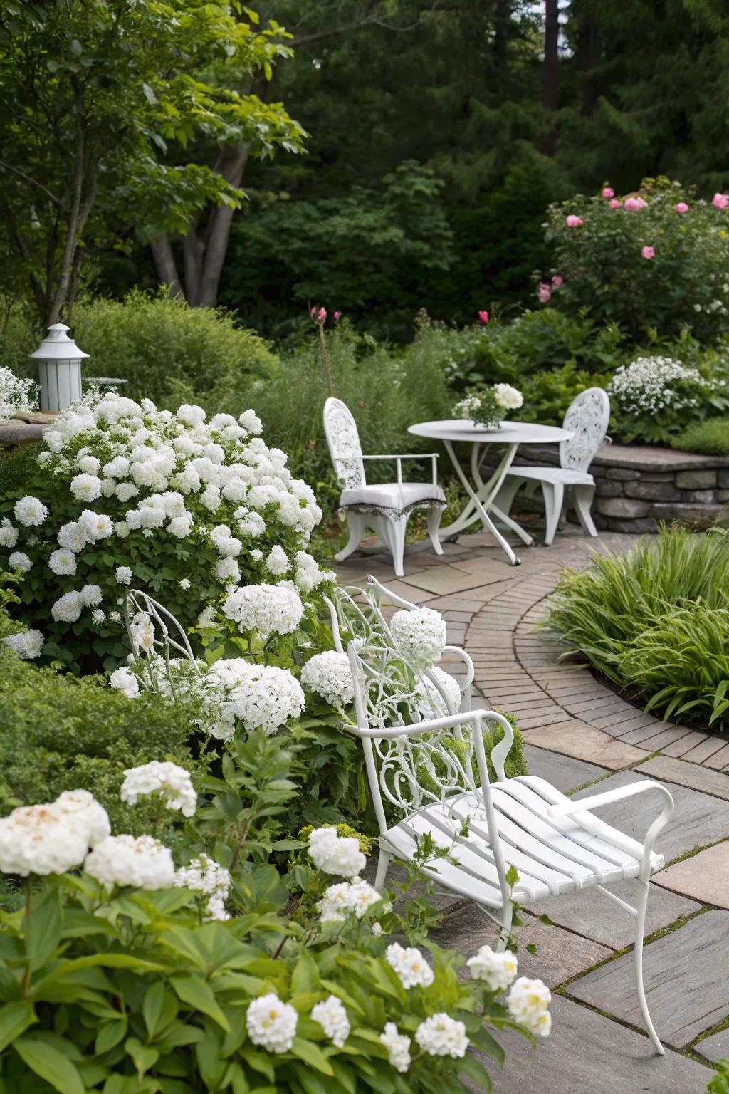 Alabaster garden furnishings harmonize with the serene aesthetic of a white garden.