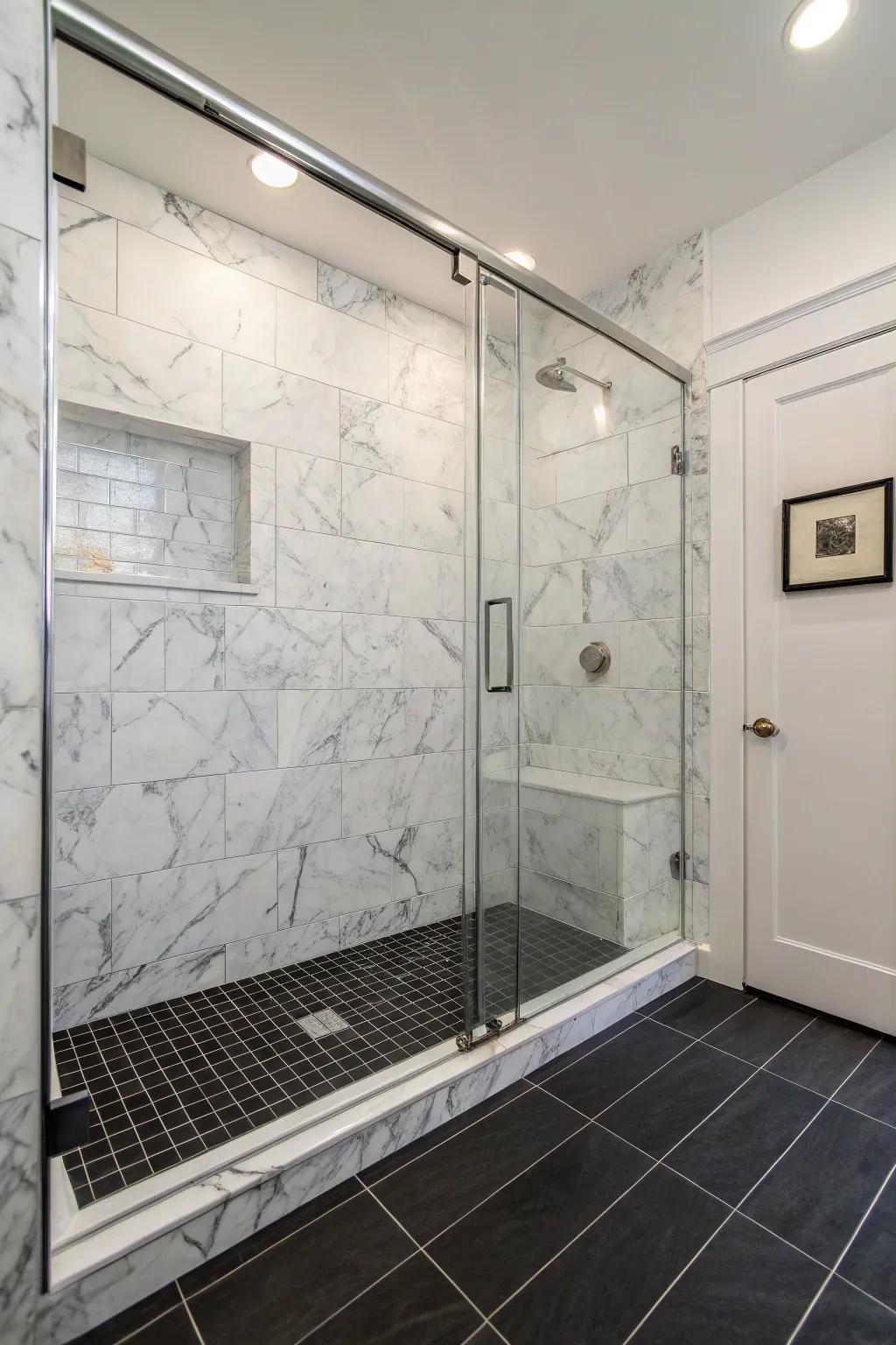 Dark floors create a striking contrast with light marble tiles.