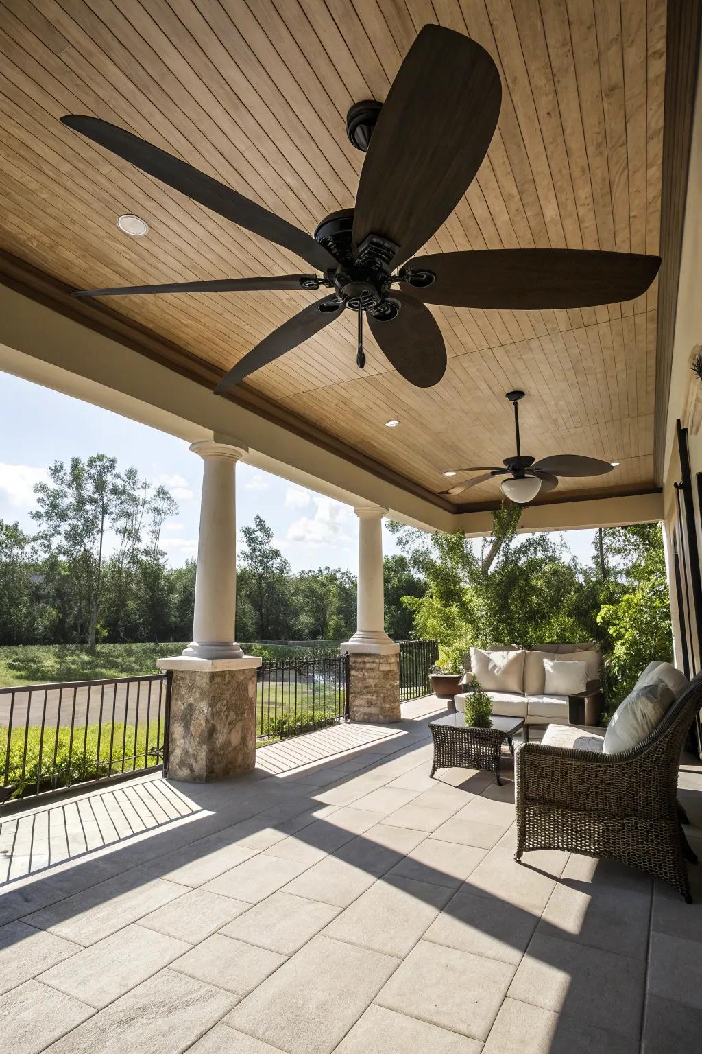 A spacious patio emphasized by a ceiling fan with extra-large wings.